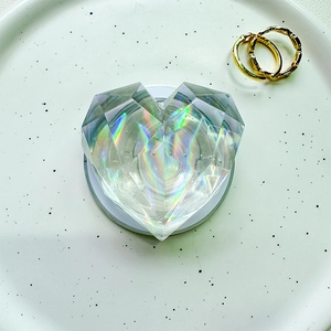 Macro detail of heart-shaped magnetic phone grip with holographic crystal facets