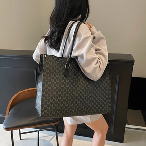 Vintage dark grey tote bag with M-letter monogram print and black leather handles