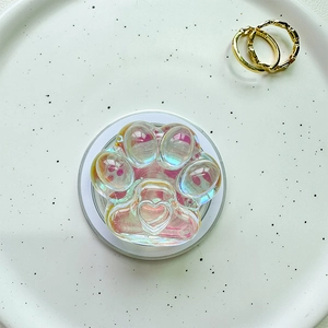 Detail of a cat paw shaped magnetic phone socket with iridescent laser resin and heart detail