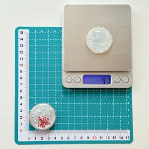 Detail view of 4cm resin flower phone socket showing weight of 9.3g on a scale