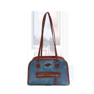 Vintage blue denim shoulder bag with brown leather trim and metal accents on white background