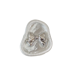 Silver flower butterfly grip stand with 3D bow design and metallic textured base