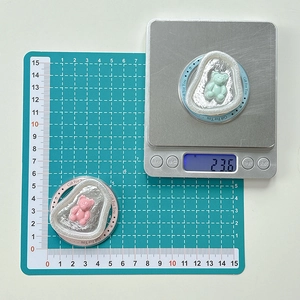 Detail showing pink and green bear phone grips with size and weight measurements