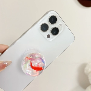 Macro detail of clear resin phone socket featuring a red goldfish and pearl decor