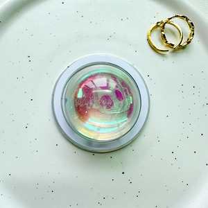 Detail of magnetic phone grip with iridescent laser finish and crystal ball design