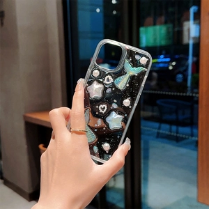 Detailed view of 3D mermaid tail, pearls, and stars on a glittery iPhone case