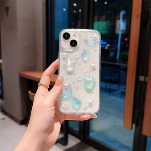 Detail view of iPhone case featuring 3D mermaid tail, pearls, and stars on clear shell