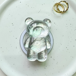 Detail of laser bear magnetic phone grip on a ceramic tray with aurora resin finish