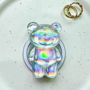 Close-up of holographic 3D bear magnetic phone grip on a white decorative tray