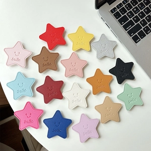 Star-shaped leather phone grip stands with smile embossing in 15 vibrant colors