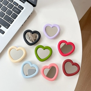 Set of eight heart-shaped silicone phone mirror grips in various pastel and bold colors