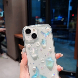 Detail of clear glitter phone case with 3D mermaid tails, stars and pearl heart decor