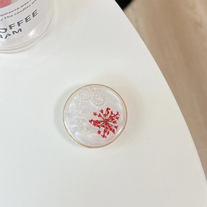 Detail of glitter flower phone grip featuring real red dried flower and pearl inlay