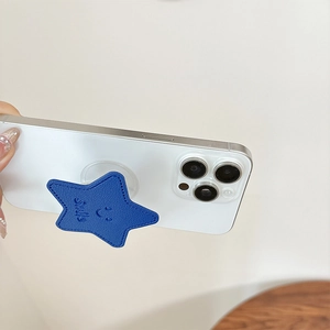 Detail of dark blue leather star phone grip with Smile engraving and stitching