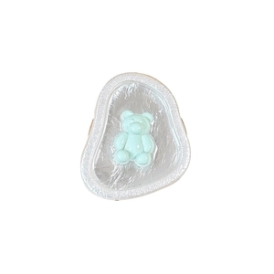 Magnetic light blue bear phone grip with stylish wavy textured base for desk viewing