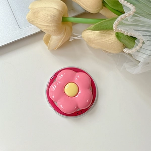 Detail of pink flower MagSafe phone socket with Gift For You engraving on a desk
