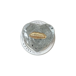 Transparent heart phone grip with silver glitter flakes and gold lip logo on gift card