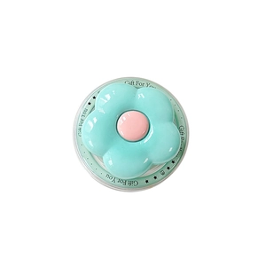 Mint green flower MagSafe phone socket grip with pink center on a gift card holder