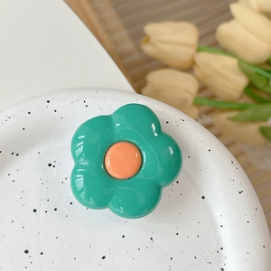 Close-up of a green flower phone socket on a white tray with tulip decor background