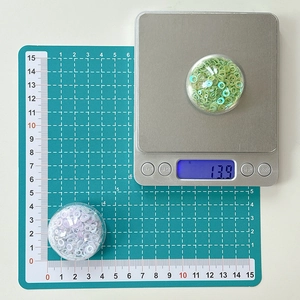 Round collapsible phone grip with mint green and pearl white polymer clay slices