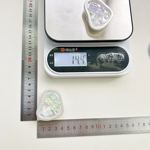 Detailed view of resin bear phone grip on scale showing weight and dimensions