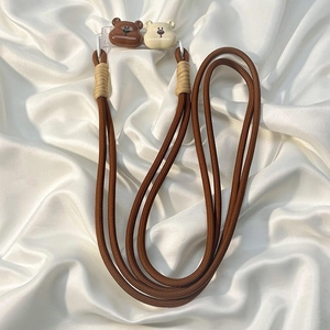 Detail of brown braided phone lanyard with cute bear charms and sturdy woven knot