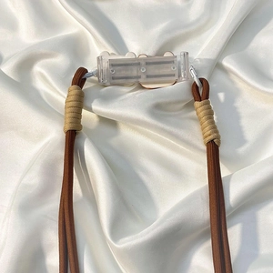 Crossbody phone strap with brown braided cord and adjustable transparent back clip
