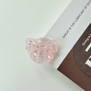 Close-up of pink butterfly phone grip with sparkling glitter sequins and sleek foldable base