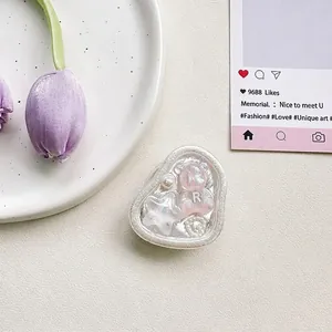 Detail of sweet bear and star resin design for a folding phone grip on white background