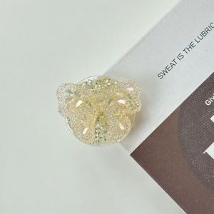 Detail of a sparkling heart-shaped Griptok phone stand with holographic glitter finish