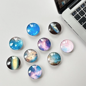 Macro shot of 9 crystal glass star nebula patterns for collapsible phone grip sockets