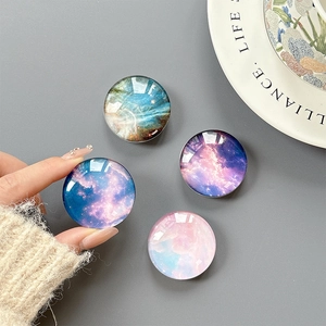 Collage of four crystal glass starry sky telescopic phone socket grips in vivid galaxy colors