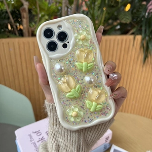 Detailed view of iPhone case featuring 3D tulips, white pearls and sparkling sequins