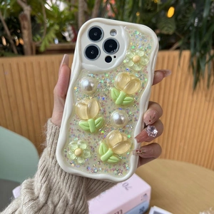 Detail of 3D yellow tulips and white pearls on glitter wavy case for iPhone
