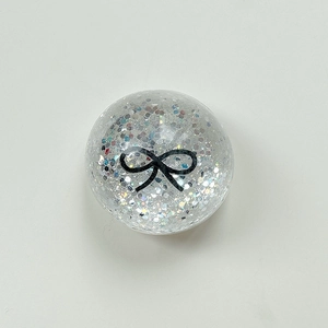 Close-up of holographic silver glitter phone socket with a black bow pattern