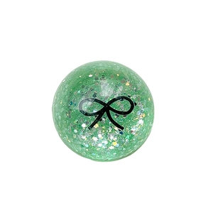 Green glitter ball phone grip with black bow pattern and retractable socket design