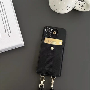 Detail of black iPhone case with textured leather wallet pocket and gold metal hooks