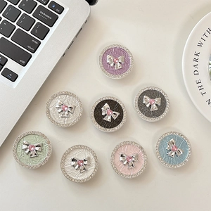 Sparkling rhinestone round phone grip with metallic bow and heart gem in various colors