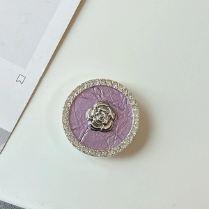 Macro detail of camellia flower phone socket with purple texture and rhinestones