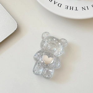 Detail of bear phone grip featuring silver glitter resin and white heart decoration