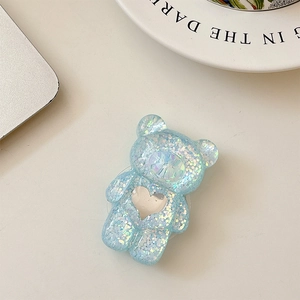 Detailed macro view of a blue glitter bear phone socket with a silver heart mirror