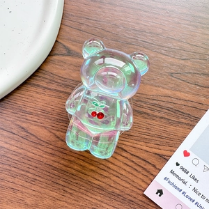 Macro detail of laser bear phone grip with cherry gems on rustic wooden table