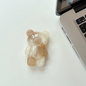 Detail of cute bear phone grip featuring translucent resin and gold foil flakes texture