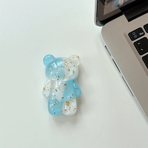 Detail of blue and white gradient bear phone grip with shiny gold foil flakes