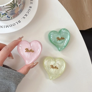 Support de téléphone coeur pailleté avec Smile en rose, vert et jaune pastel