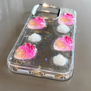 Gros plan sur la fraise 3D pailletée et fleurs sur coque transparente iPhone 16 Pro Max