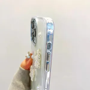 Close-up of pearl butterfly iPhone case with glossy silver plating and luxury hand strap