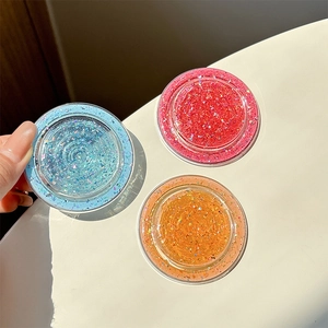 Glitter MagSafe grip sockets in blue, pink, and orange with circular spiral textures
