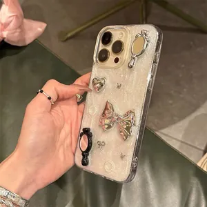Close-up of glitter iPhone case with silver bow, heart, and mirror relief accents