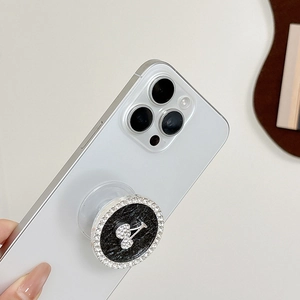 Detail of rhinestone phone socket with black glitter and silver cherry pattern